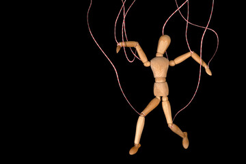 Wooden puppet doll, dancing marionette. Concept of emotional manipulation, world conspiracy theories
