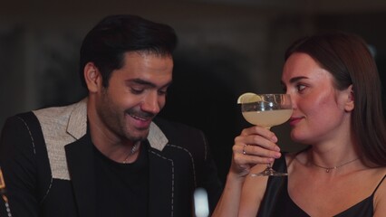 Beautiful woman zipping Margarita cocktail savoring sour tasty drink beside smart couple or friend at luxurious bar creating happiness moment in meeting at vibrant nightclub on Friday night. Vinosity.