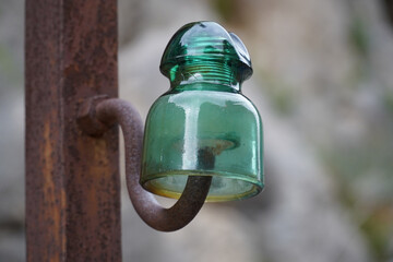 Old glass insulator from the beginning of the 20th century, when hydroelectric power stations were...