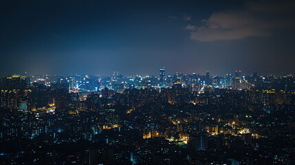 Night skyline view of a vibrant urban cityscape illuminated by lights with skyscrapers and buildings under a cloudy sky