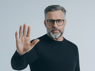 Naklejka premium Mature Businessman in Formal Wear Making Stop Gesture in Studio