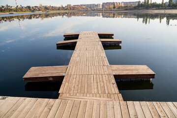 A wooden dock is leading into a lake