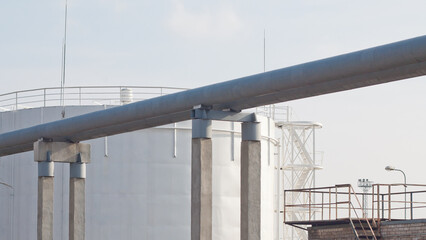 Fototapeta premium The photo shows a pipeline and a fuel storage tank
