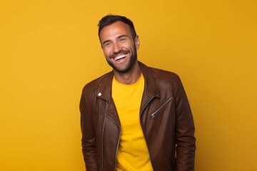 Fototapeta premium Portrait of a cheerful man in his 30s wearing a trendy bomber jacket on solid color backdrop