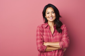 Fototapeta premium Portrait of a content asian woman in her 40s wearing a comfy flannel shirt isolated on solid color backdrop