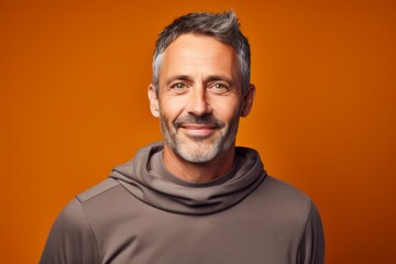 Obraz premium Portrait of a blissful man in his 40s wearing a thermal fleece pullover isolated on solid color backdrop