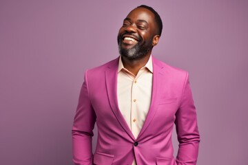 Obraz premium Portrait of a happy afro-american man in his 40s wearing a professional suit jacket in solid pastel color wall