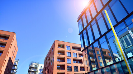 View of an modern apartment building standing next to a new modern office building with a glass...