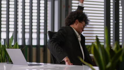 Smiling happy African American man business guy male businessman entrepreneur finish complete accomplish working online typing laptop computer end job done success achieve spinning around in chair