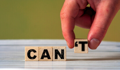 A hand placing a letter to form the word 