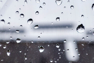 Raindrops on a window create a beautiful abstract pattern, highlighting the beauty of nature's...