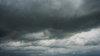 Obraz premium Overcast sky with dark clouds. Dark sky before a thunder-storm. The gray cloud background before rain.