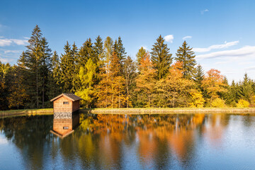 Autumn landscape with beautiful colorful trees reflected in the lake. Beskydy Mountains in Czech Republic, Europe.