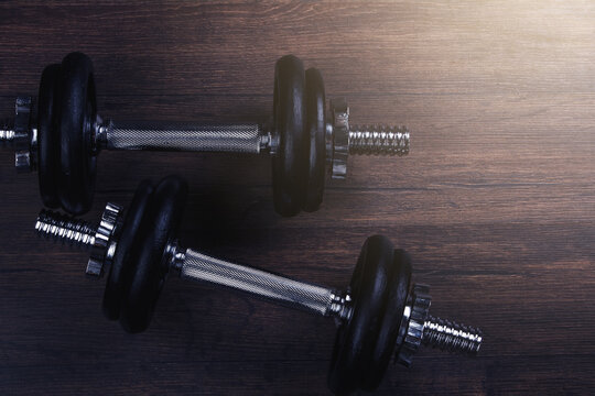 Black Dumbbell Against Dark Background