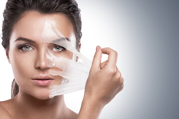 Woman Peeling Off Facial Mask for Skincare Treatment