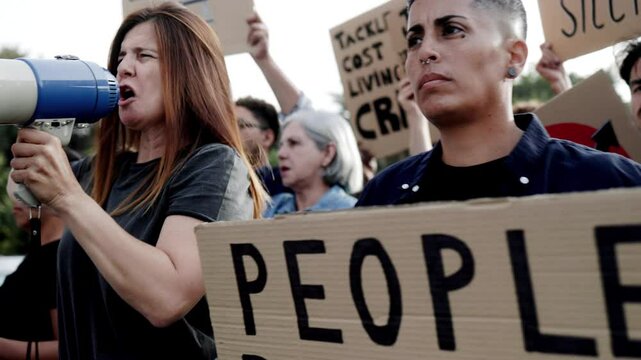 Crowd protest financial crisis on the streets. People marching for global inflation economy