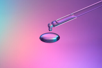 pipette mit tropfen auf farbigen hintergrund