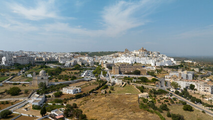 Obraz premium Panoramic aerial view of the city of Ostuni, also known as The White Town. It is located on a hill in the province of Brindisi, in Puglia, Italy. Surrounding the city is the Murgia countryside.