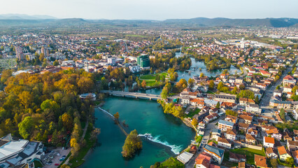 Bihać, a picturesque city in Bosnia, showcases vibrant autumn colors along the pristine River Una. The natural beauty of the area is accentuated by the golden and amber leaves that frame the riverbank