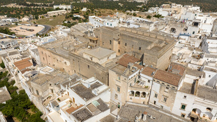 Naklejka premium Aerial view of houses, apartments and buildings in the historic center of Ostuni in the province of Brindisi, in Puglia, Italy.
