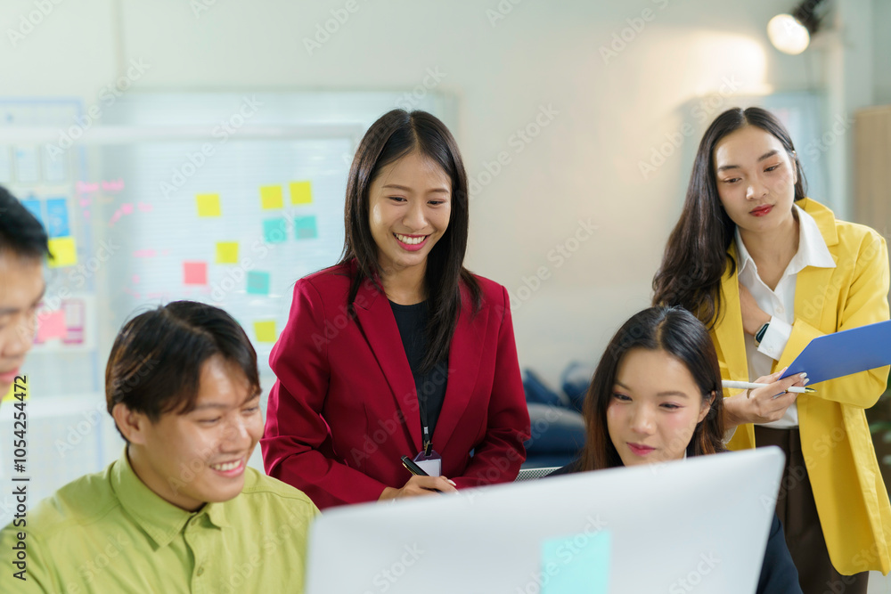 Wall mural group of young asian businesspeople discussing work using desktop computer in modern office meeting 