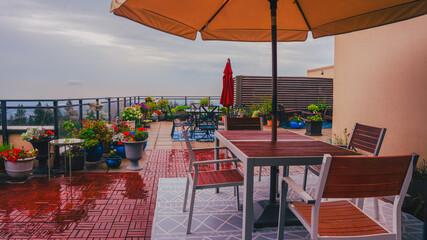 Large rooftop patio high above valley after rain.