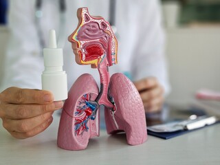 Doctor holds spray or drops in nose to treat runny nose