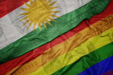 waving colorful flag of kurdistan and gay rainbow flag on the dollar money background. finance...