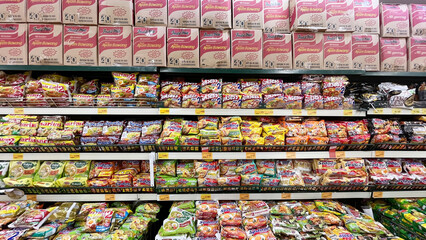 Jakarta, October 26, 2024: Grocery store shelves with instant noodles in a market in Jakarta, Indonesia. Variety brand of instant foods product on shelf rack display in a grocery store supermarket
