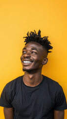 Fototapeta premium Energetic Young Man Smiling Brightly Against Vibrant Yellow Background for Joyful Design