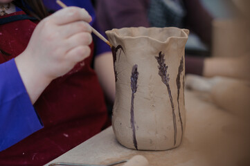 Artistic Pottery Creation: Decorative Vase Painting in a Craft Workshop
