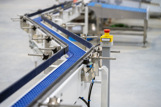 Plastic zet shaped chain conveyor and emergency button in food manufacturing plant