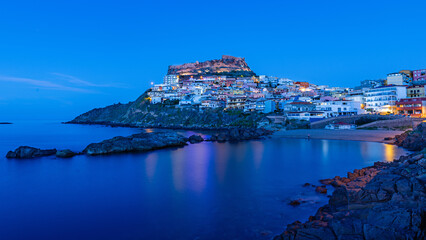 Fototapeta premium Picturesque panoramic view of medieval town of Castelsardo at night, during the blue hour, Province of Sassari, Sardinia, Italy, Europe.
