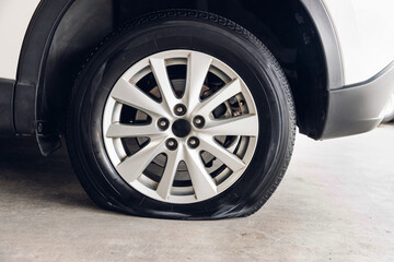 Destroyed blown out tire with exploded, shredded and damaged tire on a modern automobile. damaged truck rubber after tire explosion at high speed. Damaged flat tires: old car.