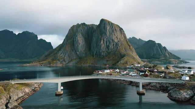 Aerial drone view of a bridge connecting 2 islands in Lofoten with the sea around, Lofoten Islands, Reinebringen