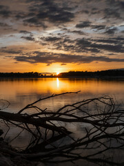 Landscape of a lake with the reflection of the mountains and clouds at autumn sunset in Granada (Spain)