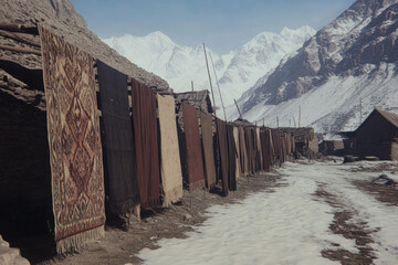 Naklejka premium A row of colorful rugs are displayed outside of a building