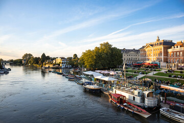 Richmond Upon Thames riverside area bustling with anonymised people in the early evening