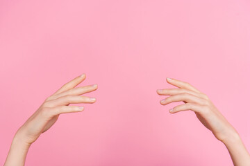 Cropped close up photo of woman arms fingers raise empty space isolated on pink color background