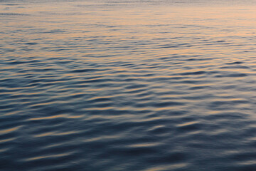 orange sunset over a wavy calm sea background texture wallpaper