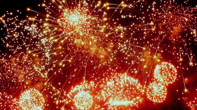 Brilliant bursts of color light up the night as fireworks explode in mesmerizing slow motion, creating a stunning visual spectacle.