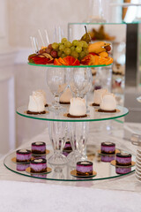 Elegant Dessert Display with Fruits and Pastries on Glass Stands