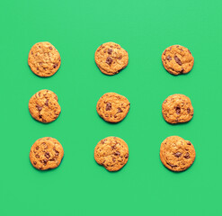 Chocolate chip cookies minimalist on a green background, above view