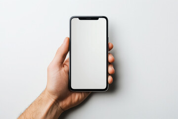 Male hand holding a smartphone with white blank mockup screen, isolated on white background