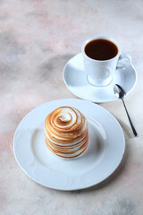 Sweet marshmallows. Meringue with honey layer. Dessert on white plate with cup of coffee. Concept of food and drinks.