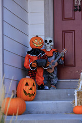Various colorful Fall and Halloween yard and porch decorations