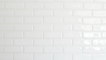 Modern white subway tile wall with glossy finish and even grout lines creating a clean grid pattern