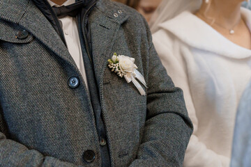 Elegant Wedding Attire Featuring Boutonniere and Bridal Ensemble