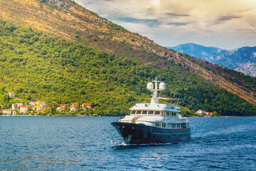 A small pleasure yacht in the open blue sea off the coast of Kotor in Montenegro