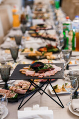 Abundant Feast Display Featuring a Variety of Appetizers and Drinks on a Long Dining Table